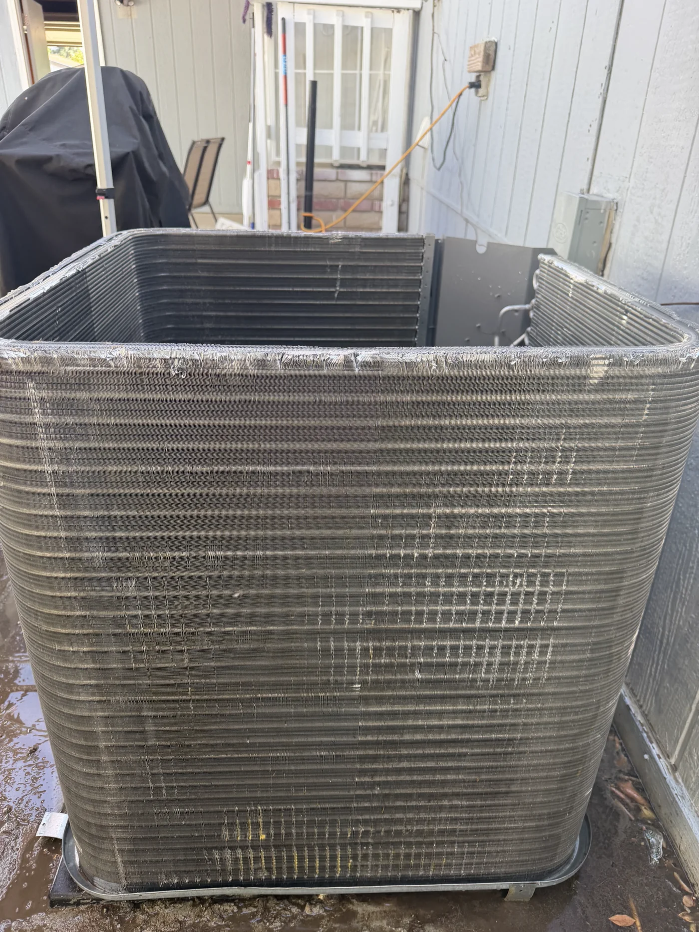 Cleaned outdoor condenser coil after maintenance rinsing.